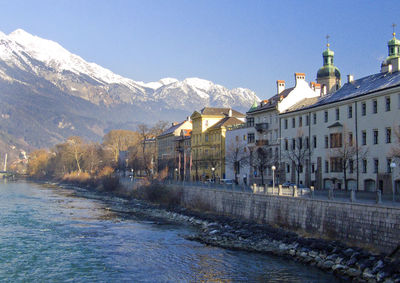 Buildings in city against clear sky during winter