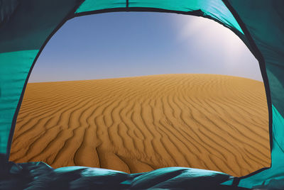 Scenic view of desert against clear blue sky