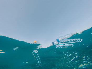 Swimming pool in sea against sky