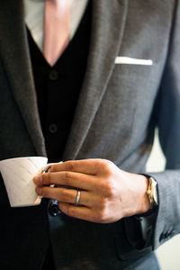 Close-up of man holding hands at home