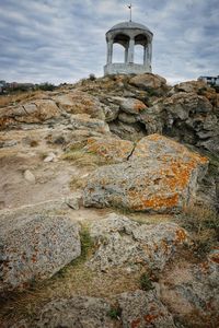 Low angle view of rock formations against sky