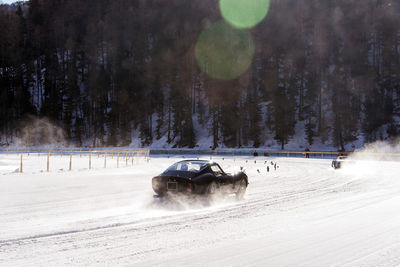 Classic vintage car on the frozen lake of saint moritz in a race