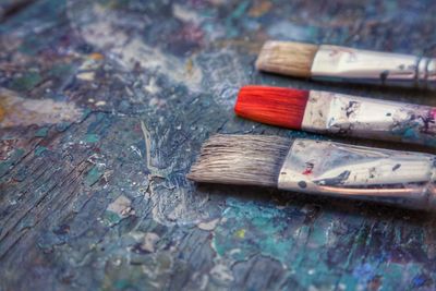 Close-up of paintbrushes on wood