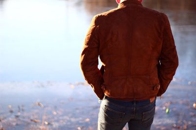 Rear view of man standing against sky