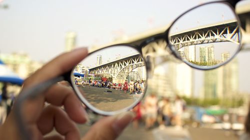 Close-up of hand on bicycle in city