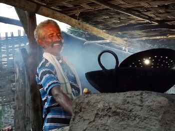 Portrait of senior man holding camera