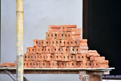 Close-up of stack of firewood against wall