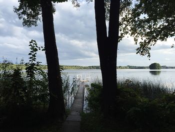 Scenic view of lake against cloudy sky