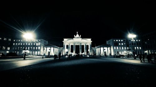 Statue in city at night