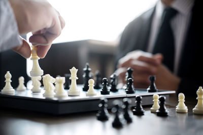 Close-up of business colleagues playing chess in office