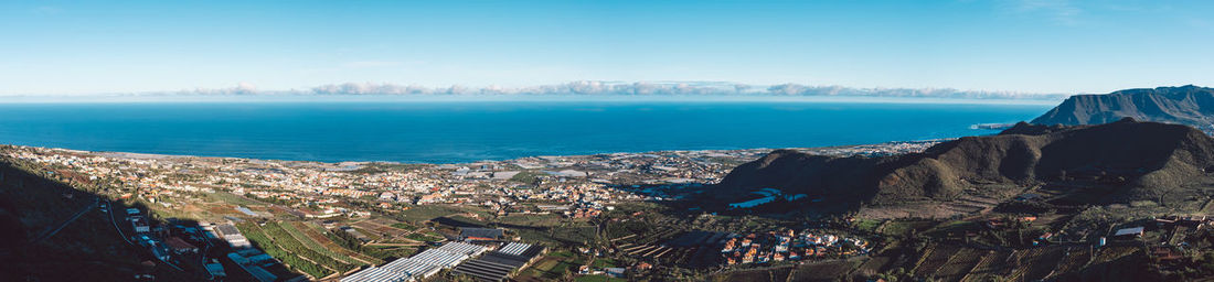 High angle view of buildings and sea against sky