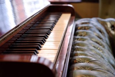 Close-up of piano by sofa