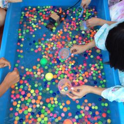 Colorful girl playing with multi colored balloons