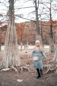 Full length of woman walking in forest