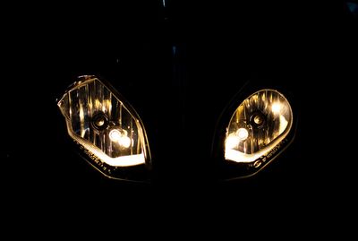 Close-up of illuminated light bulb in the dark