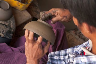 Bagan, myanmar - december 23, 2011. a lacquer-ware worker crafting pottery