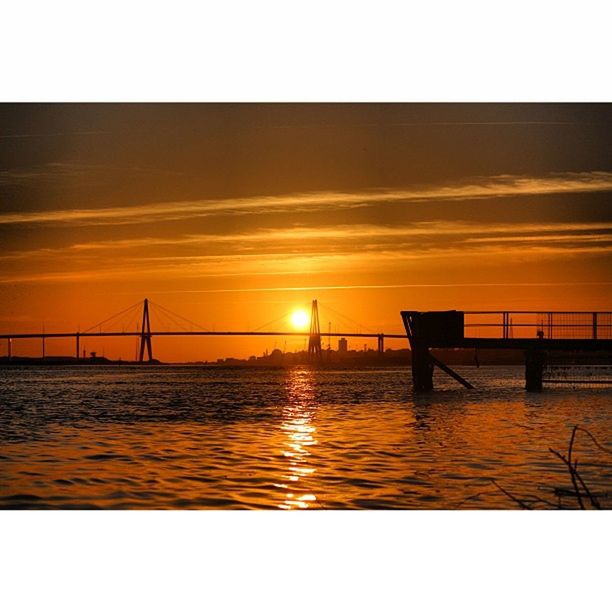 sunset, transfer print, water, sea, sun, sky, auto post production filter, scenics, tranquil scene, orange color, tranquility, beauty in nature, waterfront, nature, built structure, pier, reflection, silhouette, connection, rippled