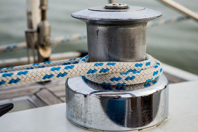 Close-up of rope tied to bollard on boat