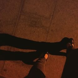 Low section of woman standing on tiled floor