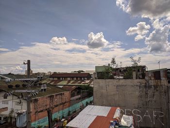 High angle view of buildings in town against sky