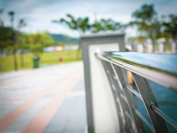 Close-up of railing on footpath