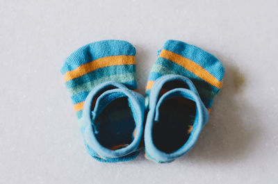 High angle view of multi colored shoes on white background