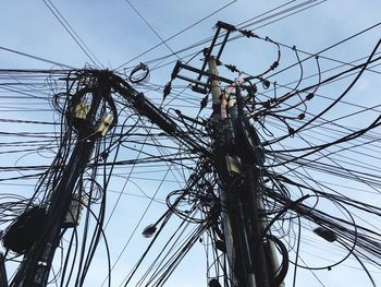 Low angle view of electricity pylon against sky