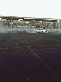 Cars on street in city against clear sky