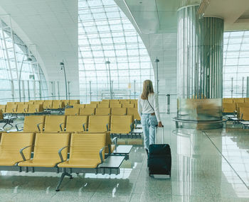 Woman lying in airport lobby