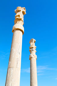 Low angle view of statue against blue sky