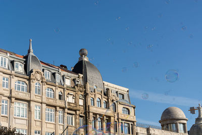 Low angle view of buildings against blue sky