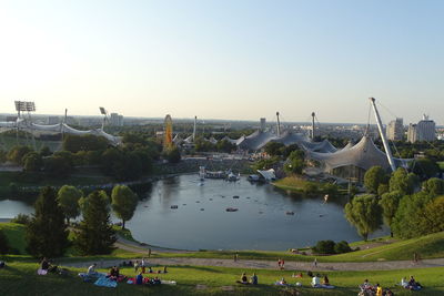 Panoramic view of people and buildings in city against clear sky