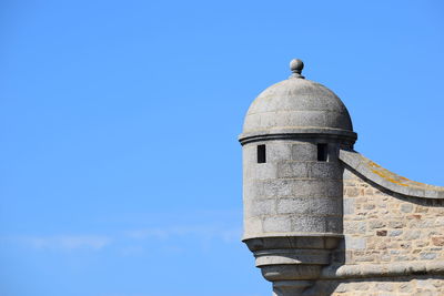 Low angle view of historic building against clear blue sky