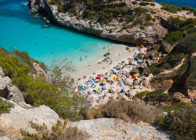 High angle view of people on rocks by sea