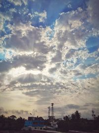 Low angle view of building against cloudy sky