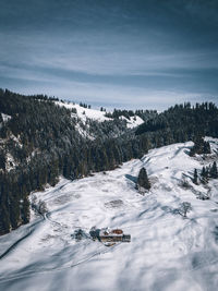 Snow covered land against sky
