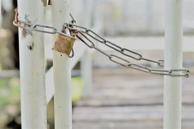 Close-up of chain hanging on fence