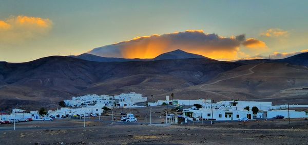 Scenic view of snowcapped mountains against sky during sunset