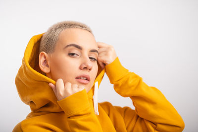 Portrait of beautiful young woman against white background