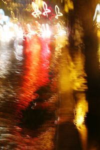 Close-up of wet illuminated city during rainy season