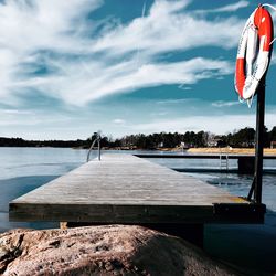 Pier on beach against sky