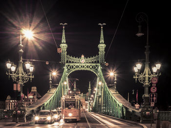 Illuminated bridge at night