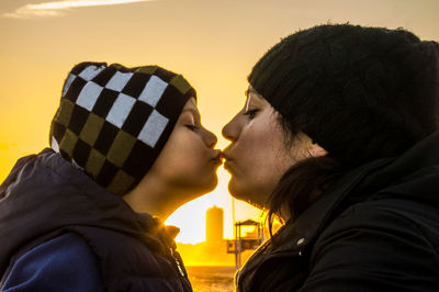 Close-up of young couple against sky