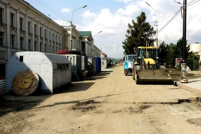 Vehicles on road against buildings