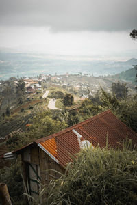 High angle view of houses and buildings against sky