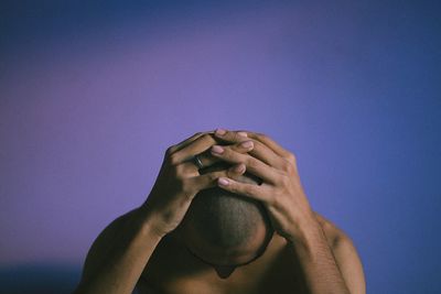 Man contemplating against blue background