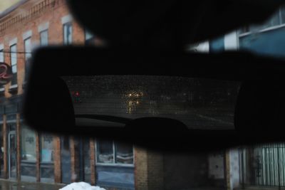 Close-up of car against building in city
