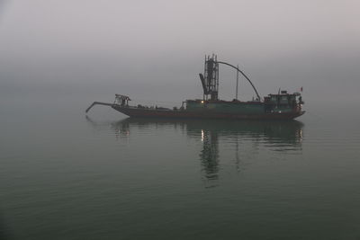 Ship in sea against sky