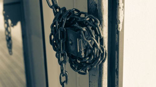 Close-up of chain hanging on metal door