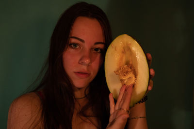 Portrait of woman holding melon